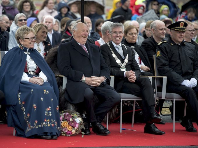 Kongen følger programmet på idrettsplassen på Vikeså sammen med fylkesmann Magnhild Meltveit Kleppa og ordfører i Bjerkreim Torbjørn Ognedal. Foto: Carina Johansen / NTB Scanpix